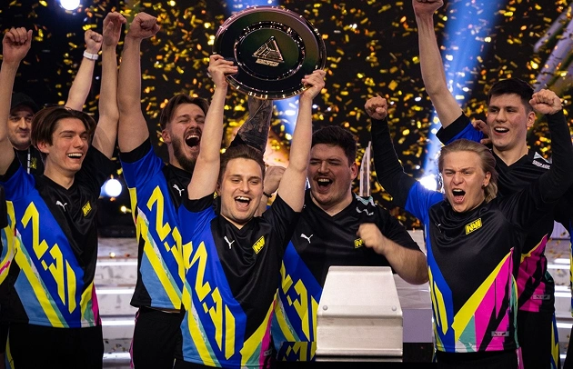 Zespół NAVI świętuje zwycięstwo z trofeum i konfetti na podium